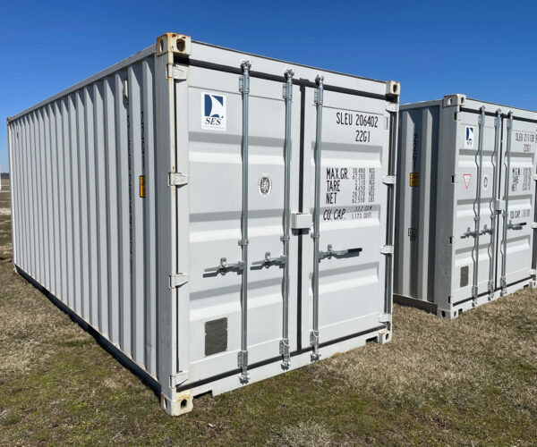 Side view of multiple white storage containers in a row, showing the uniform ribbed exteriors and identification numbers.