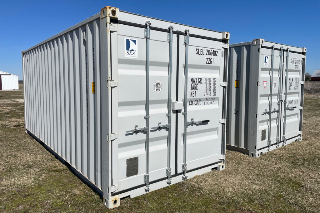 Side view of multiple white storage containers in a row, showing the uniform ribbed exteriors and identification numbers.